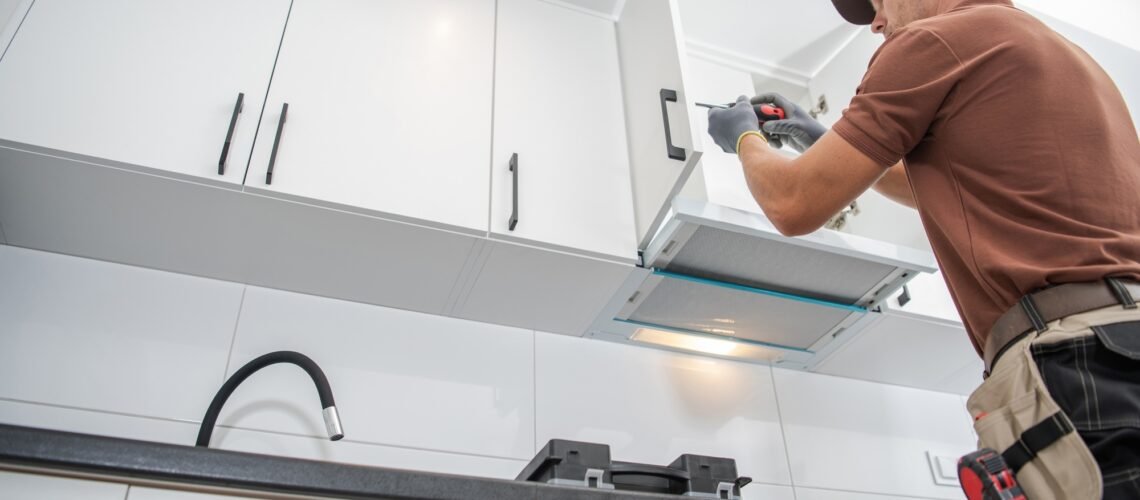 Contractor Worker Assembling of New Apartment Kitchen Cabinets
