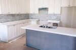 New bright modern kitchen with an island being installed