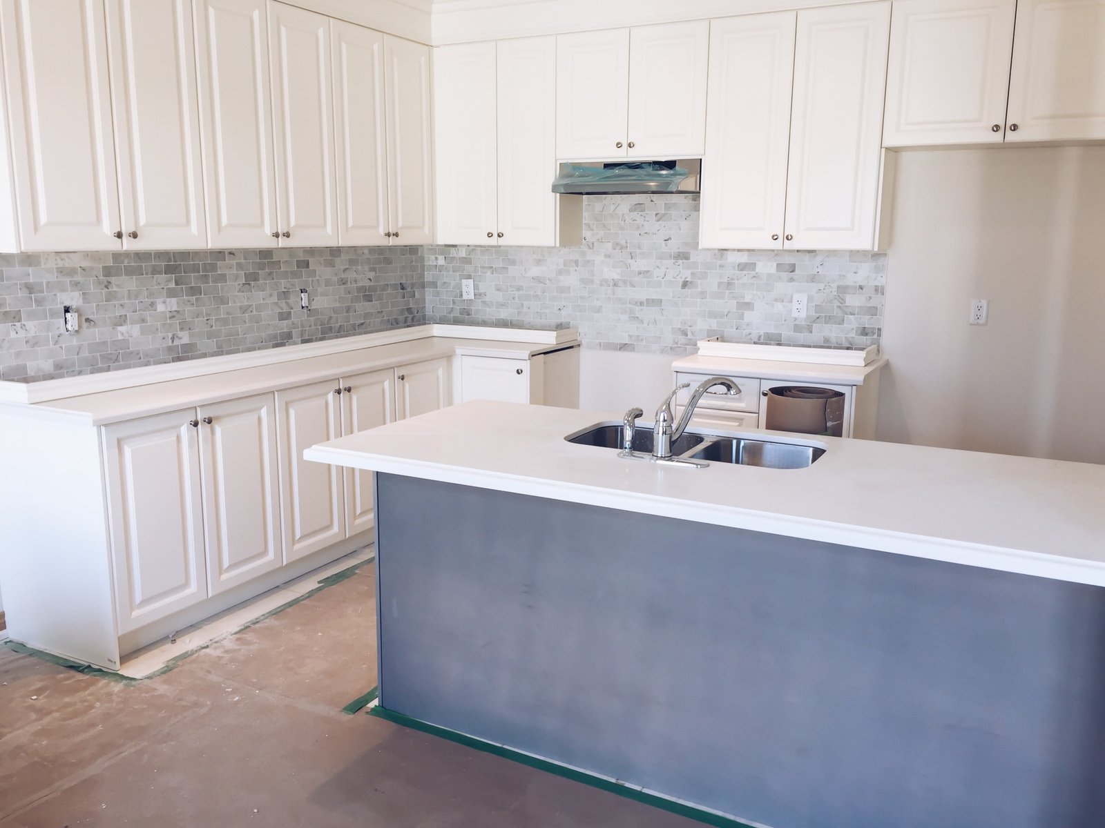 New bright modern kitchen with an island being installed